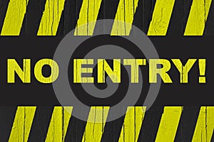 Ã¢â¬ÅNo Entry!Ã¢â¬Â warning sign with yellow and black stripes painted over cracked wood.